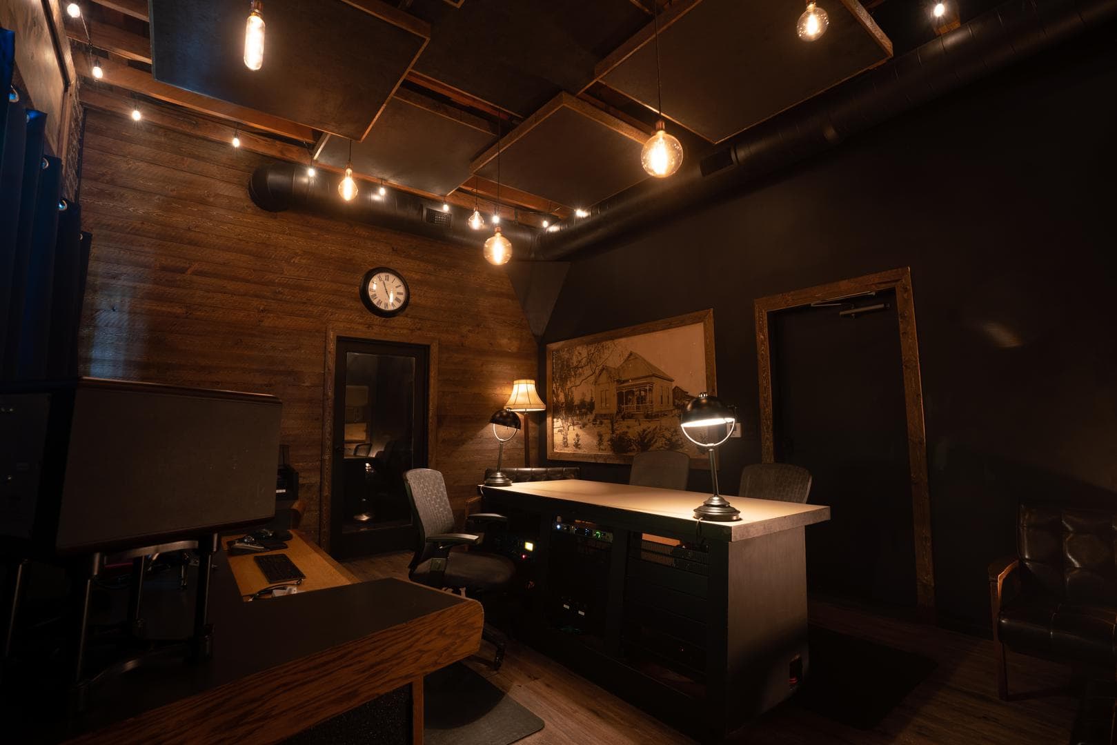 The Weddington room with reclaimed wood, Edison bulb pendants, and the house photo